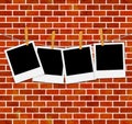 Set of photo frames on rope with clothespins on brick wall Royalty Free Stock Photo