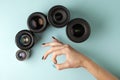 Set of photo lenses on a colored background, the selection and comparison of photographic equipment, hands are holding photo Royalty Free Stock Photo