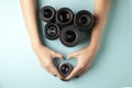 Set of photo lenses on a colored background, the selection and comparison of photographic equipment, hands are holding photo Royalty Free Stock Photo