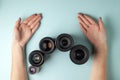 Set of photo lenses on a colored background, the selection and comparison of photographic equipment, hands are holding Royalty Free Stock Photo