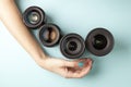 Set of photo lenses on a colored background, the selection and comparison of photographic equipment, hands are holding Royalty Free Stock Photo