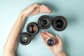 Set of photo lenses on a colored background, the selection and comparison of photographic equipment, hands are holding Royalty Free Stock Photo