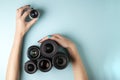 Set of photo lenses on a colored background, the selection and comparison of photographic equipment, hands are holding photo Royalty Free Stock Photo