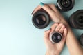 Set of photo lenses on a colored background, the selection and comparison of photographic equipment, hands are holding Royalty Free Stock Photo