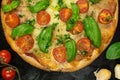 Keto Tortilla Pizza with Shredded Mozzarella, Sliced Cherry Tomatoes and Basil