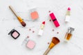 Set of pink cosmetics. Lipstick, bulk, eyeshadow, perfume near brushes on white background top view Royalty Free Stock Photo