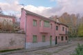 Set of pink cottages with green windows