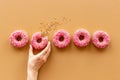 Set of pink glazed donutes with sprinkles, top view