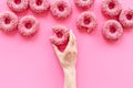 Set of pink glazed donutes with sprinkles, top view