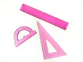 Set of pink measuring tools: rulers, triangles, protractor. Correct form and sizes. Metric system of measurements: centimeters and