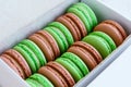 Set of pistachio and caramel macaroon in white box