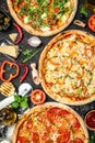 Set Pizza background. various kinds of Italian pizza on a dark background, Fast food lunch, vertical image. top view. place for