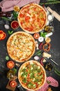 Set Pizza background. various kinds of Italian pizza on a dark background, Fast food lunch, vertical image. top view. place for