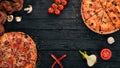 Set pizza. Italian cuisine. Top view. On a wooden background. Royalty Free Stock Photo