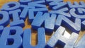 Set of plastic alphabet letters placed on a wooden floor Royalty Free Stock Photo