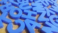 Set of plastic alphabet letters placed on a wooden floor Royalty Free Stock Photo