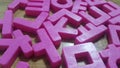 Set of plastic alphabet letters placed on a wooden floor Royalty Free Stock Photo