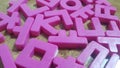 Set of plastic alphabet letters placed on a wooden floor Royalty Free Stock Photo