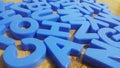 Set of plastic alphabet letters placed on a wooden floor Royalty Free Stock Photo