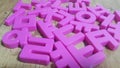 Set of plastic alphabet letters placed on a wooden floor Royalty Free Stock Photo