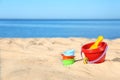 Set of plastic beach toys on sand near sea.  for text Royalty Free Stock Photo