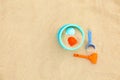 Set of plastic beach toys on sand, top view Royalty Free Stock Photo