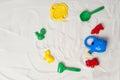 Set of plastic beach toys on sand, top view. Space for text Royalty Free Stock Photo