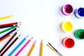 set of plastic cans with colored paints, brushes, pencils, pens on white background. Royalty Free Stock Photo