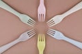 Set of plastic cutlery in different colors spoons forks knives on the kitchen table and eco-friendly plastic Royalty Free Stock Photo