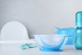 Set of plastic dishware on white table indoors, space for text. Serving baby food Royalty Free Stock Photo