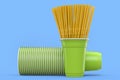 Set of plastic disposable party cups for coffee with heap straw on blue