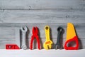 Set of plastic toy tools for children in a line on a wooden background Royalty Free Stock Photo