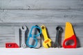 Set of plastic toy tools for children on a wooden background Royalty Free Stock Photo