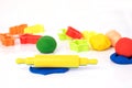 Set of play dough and plastic cutting block on white. Royalty Free Stock Photo