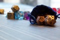 A set of polyhedral dice with a draw string bag Royalty Free Stock Photo