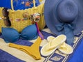 Beach accessories on pastel backgrounds-glasses, hat, towel, flip flops, fan, sunscreen, bag and bikini Royalty Free Stock Photo