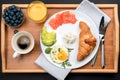 A set of products for a delicious European Breakfast on a wooden tray. Royalty Free Stock Photo