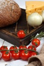 A set of products from fresh, crisp bread, cheese, onions and cherry tomatoes on the table before cooking Royalty Free Stock Photo