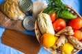 A set of products pasta, buckwheat, rice, canned food all lies next to the basket which contains oranges, lemons Royalty Free Stock Photo