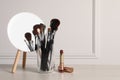 Set of professional brushes, lipstick and mirror on wooden table indoors, space for text Royalty Free Stock Photo