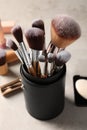 Set of professional brushes and makeup products on grey table Royalty Free Stock Photo