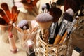Set of professional brushes and makeup products near mirror on wooden table, closeup Royalty Free Stock Photo