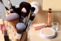 Set of professional brushes and makeup products near mirror on wooden table, closeup. Space for text Royalty Free Stock Photo