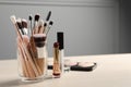 Set of professional brushes and makeup products on wooden table indoors, space for text Royalty Free Stock Photo
