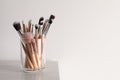 Set of professional brushes on wooden table against white background, space for text Royalty Free Stock Photo