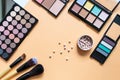 Set of professional decorative cosmetics, makeup tools and accessory on yellow background. Beauty, fashion, party and shopping Royalty Free Stock Photo