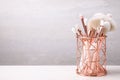 Set of professional makeup brushes in holder on white wooden table. Space for text Royalty Free Stock Photo