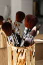 Set of professional makeup brushes near mirror on wooden table, closeup Royalty Free Stock Photo