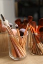 Set of professional makeup brushes near mirror on wooden table, closeup Royalty Free Stock Photo