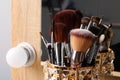 Set of professional makeup brushes near mirror on wooden table, closeup Royalty Free Stock Photo